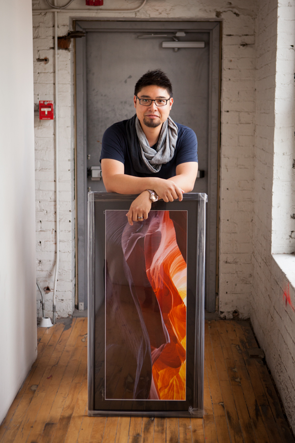 Fine art photographer and SAIT graduate Jeff Cruz in his downtown studio with one of his framed prints, titled "Antelope Waves." Cruz recently celebrated the four-year anniversary of his photography business.— Amanda Siebert, The WEAL